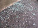 Glass from blown-out car windows on the ground after a violent storm rolled through