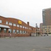 The old DHL and Danker Furniture warehouses, with the Millennium apartment building in the background The old DHL and Danker Furniture warehouses, with the Millennium apartment building in the background