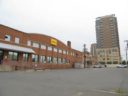 The old DHL and Danker Furniture warehouses, with the Millennium apartment building in the background