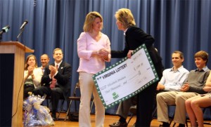 Second grade teacher Elizabeth Abraham is presented with the Va. Lottery 