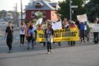 Pro-immigrant demonstrators march to a rally in Courthouse