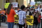 Pro-immigrant demonstrators march to a rally in Courthouse