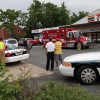 A car struck and toppled a light pole in a 7-Eleven parking lot