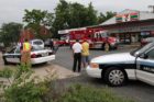 A car struck and toppled a light pole in a 7-Eleven parking lot