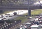 A car crosses the median on I-66 to avoid backups caused by a truck fire