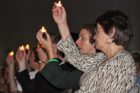 School board members hold candles in the air