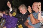 Audience members, including Arlington's police and fire chiefs, hold candles in the air