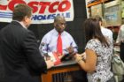 Republican presidential candidate Herman Cain signing books at the Pentagon City Costco