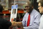 Republican presidential candidate Herman Cain signing books at the Pentagon City Costco