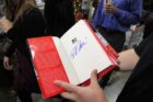 Republican presidential candidate Herman Cain signing books at the Pentagon City Costco