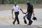 Bomb squad members and police officers investigate suspicious packages near I-66 and the Patrick Henry Drive overpass