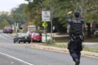 Bomb squad members and police officers investigate suspicious packages near I-66 and the Patrick Henry Drive overpass