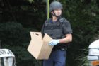 Bomb squad members and police officers investigate suspicious packages near I-66 and the Patrick Henry Drive overpass