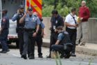 Bomb squad members and police officers investigate suspicious packages near I-66 and the Patrick Henry Drive overpass