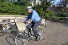 Rep. Jim Moran departs the Bike to Work Day pit stop in Rosslyn via bicycle