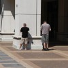 Two men recharge their cell phones outside in Courthouse on Saturday