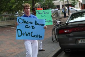 Actor Kal Penn and former White House official Aneesh Chopra talk with Obama supporters in Arlington