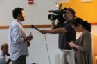Actor Kal Penn and former White House official Aneesh Chopra talk with Obama supporters in Arlington