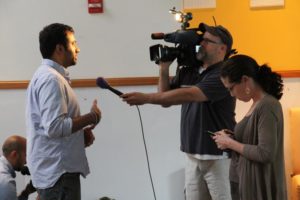 Actor Kal Penn and former White House official Aneesh Chopra talk with Obama supporters in Arlington