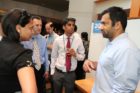 Actor Kal Penn and former White House official Aneesh Chopra talk with Obama supporters in Arlington