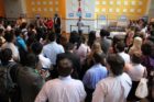 Actor Kal Penn and former White House official Aneesh Chopra talk with Obama supporters in Arlington