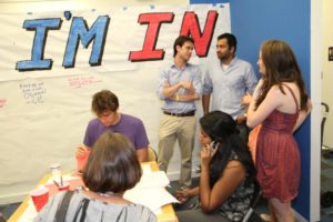 Actor Kal Penn and former White House official Aneesh Chopra talk with Obama supporters in Arlington