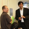 Actor Kal Penn and former White House official Aneesh Chopra talk with Obama supporters in Arlington