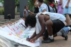 A candlelight vigil was held in the Hall's Hill community for homicide victims Keefe Spriggs and Carl Moten