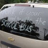 Words of protest seen on the back of a minivan, outside Oakridge Elementary School