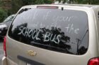 Words of protest seen on the back of a minivan, outside Oakridge Elementary School