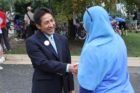County Board member Walter Tejada talks to a resident outside Oakridge Elementary School