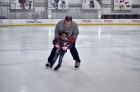 Washington Capitals Strength and Conditioning Coach Mark Nemish teaches a child to skate during Monumental Sports & Entertainment’s holiday party