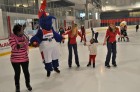 Washington Wizards mascot G-Wiz and Washington Capitals spirit squad members – Red Rockers – skate with a family at Kettler Capitals Iceplex