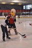 Washington Capitals mascot Slapshot instructs a child on stickhandling and shooting during Monumental Sports & Entertainment’s Family-to-Family holiday party