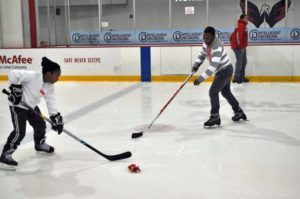 Children run through shooting drills during Monumental Sports and Entertainment’s holiday party for families