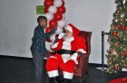 A child shares his holiday wish list with Santa during Monumental Sports and Entertainment’s holiday party