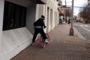 An alleged bike thief takes off on the victim's pink-tired bike (courtesy photo)