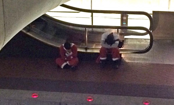 Tuckered out Santas at the Pentagon City Metro station