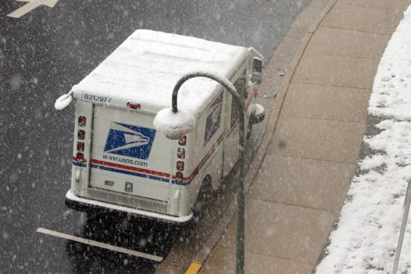 A US Postal Service truck in the snow