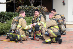 Firefighters gather during a Falls Church office fire