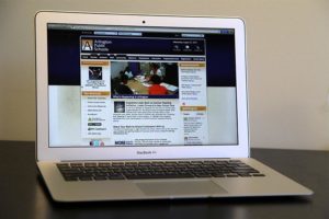 Apple Macbook Air laptop displaying the Arlington Public Schools website
