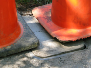 A man partially fell through this plastic utility cover on Crystal Drive