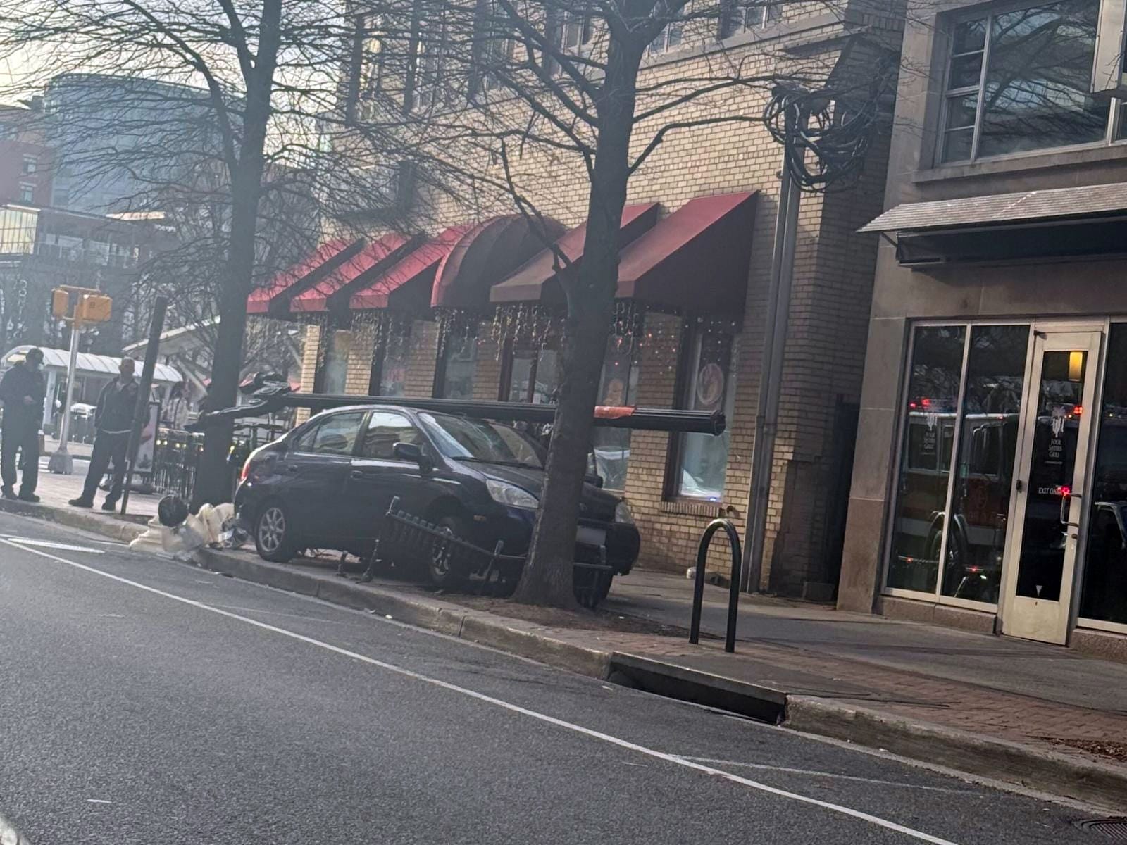 Car knocks down light pole, smashes bench in Clarendon crash | ARLnow.com
