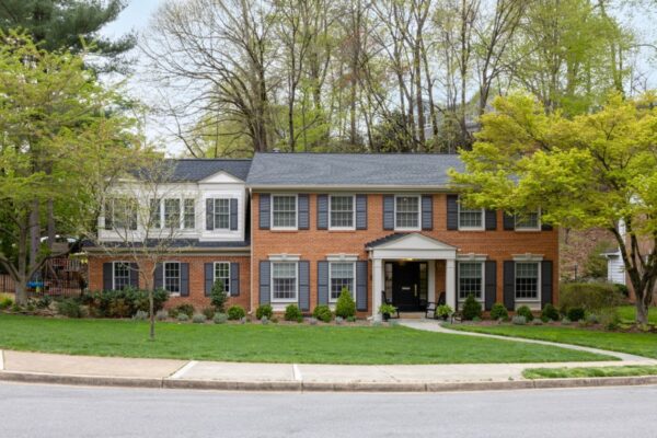 This 1960s colonial in North Arlington was reimagined by removing the four large columns in front, adding a five-foot extension across the back, and building above the existing garage. Photo Credit: Christy Kosnic Photography