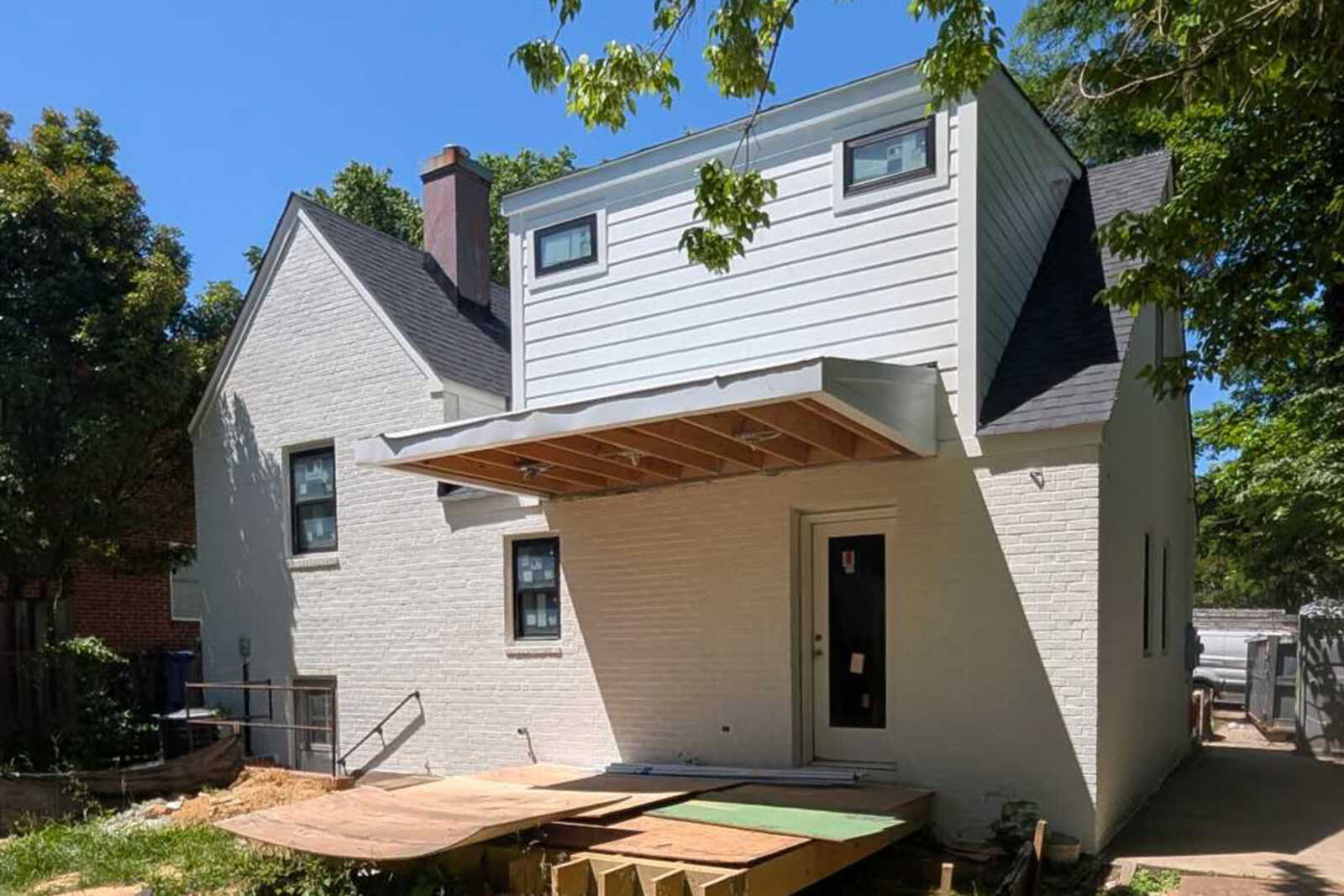 Front and rear dormer addition with a covered porch currently under construction by Alair Arlington.