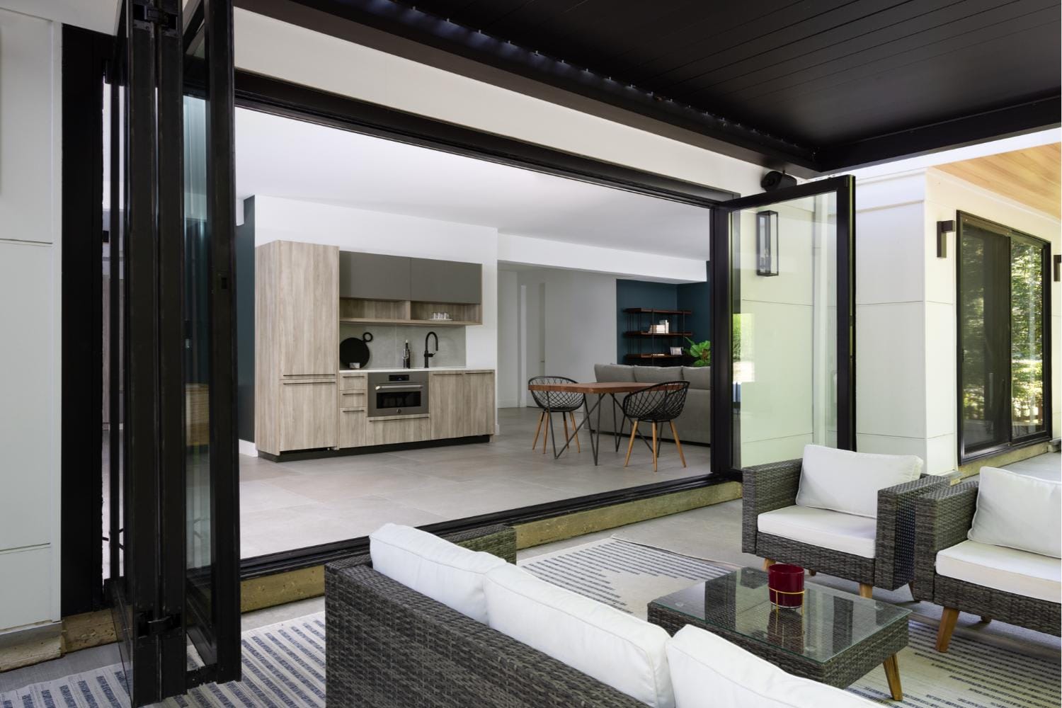 The Centor folding door allows for seamless indoor-outdoor living in this award-winning custom home built by Alair Arlington. Photo by Christy Kosnic Photography.