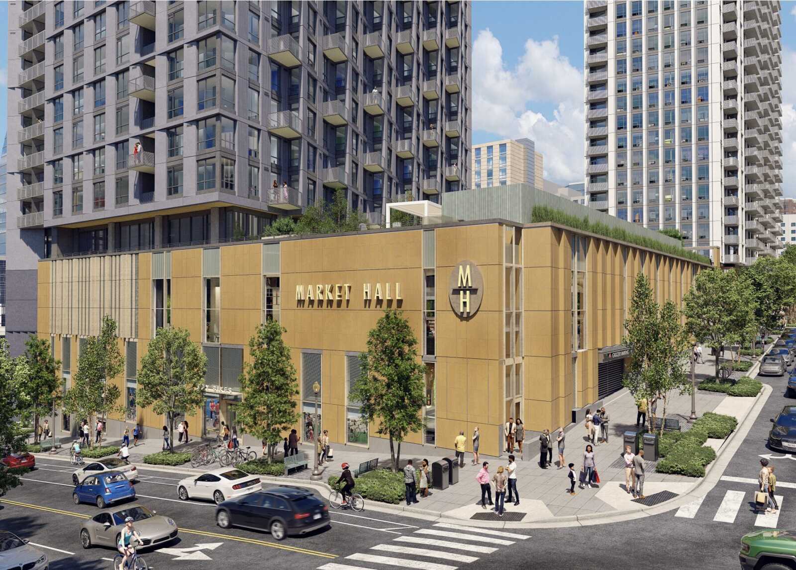 Mixed-use urban streetscape with a gold-toned Market Hall at street level and tall residential towers behind; pedestrians, cyclists, and cars on a sunny day.