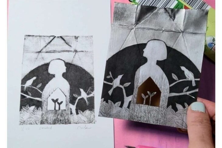 Two monochrome art prints show a white silhouette inside a house-shaped frame against a dark, leafy background; a hand holds the right print.