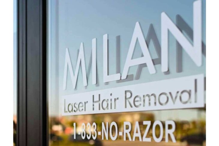Storefront window sign reading MILAN with 'Laser Hair Removal' and the phone number 1-833-NO-RAZOR.