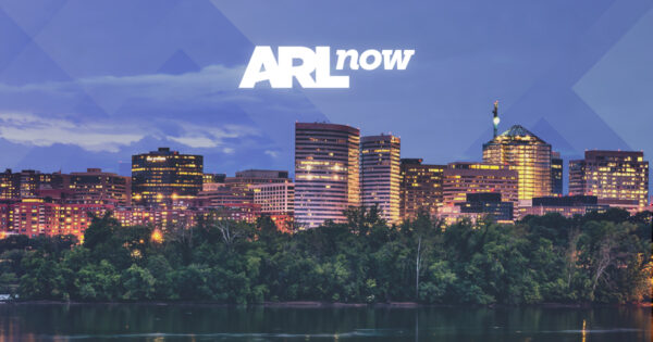 City skyline at dusk with illuminated buildings and a centered ARL now logo above. **Note:** If used as branding, the logo and skyline convey a city-focused message.